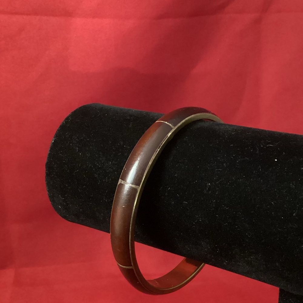 Brown (leather?) and brass bracelet